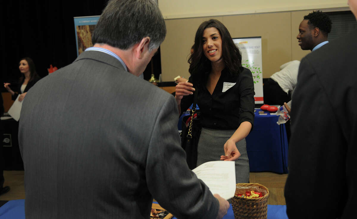 Edith Hurtado, 22, right, of Spring, and a student in the Sam Houston State University's banking program scheduled to graduate in the Fall of 2015, visits with Paul Gibbins, a financial examiner from the Houston office of Texas Dept. of Banking, during the Business Career Fair in the Lowman Student Center at SHSU on Feb. 10.