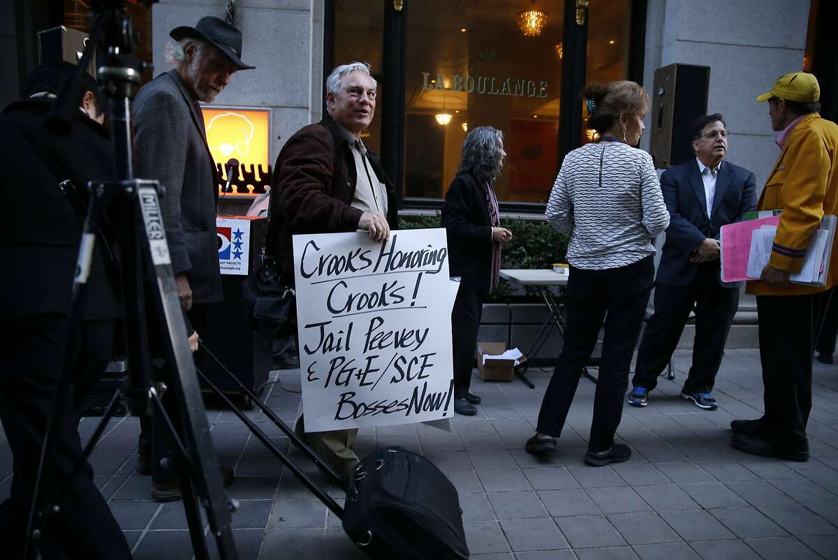 Steve Zeltzer (with sign) gathers with other protesters before a tribute dinner for California Public Utilities Commission former president Michael Peevey at Julia Morgan ballroom in San Francisco, Calif. on Thursday, February 12, 2015.