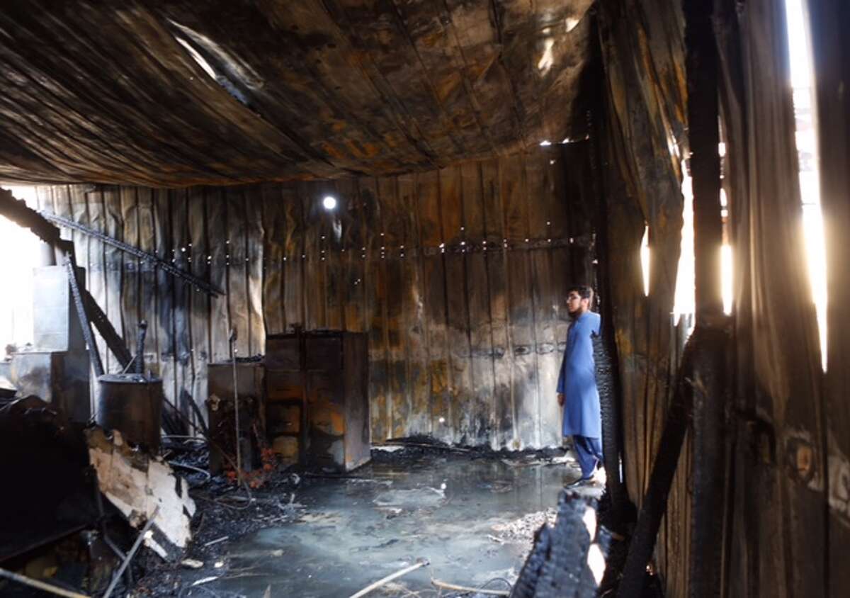 Ahsan Zahid, assistant Imam, walks through the charred Quba Islam Institute after it burned Friday morning, Feb. 13, 2015.