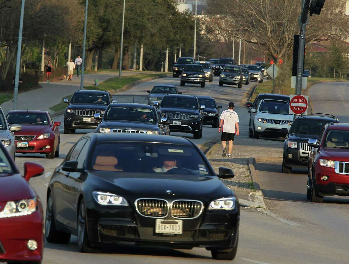 Pat Dunnahoo center, waits for traffic to cross Allen Parkway near Taft street on Feb. 12. How traffic and pedestrian access is handled is part of a new transportation discussion in Houston.