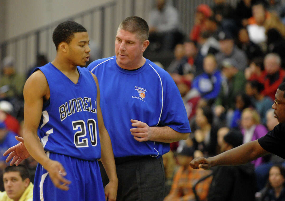 #20 Aaron Woods and Bunnell coach Pat Yerina at the Class L boys basketball semifinal action between Bunnell and Windsor at the Floyd Little Athletic Center in New Haven, Conn. on Tuesday March 18, 2014.
