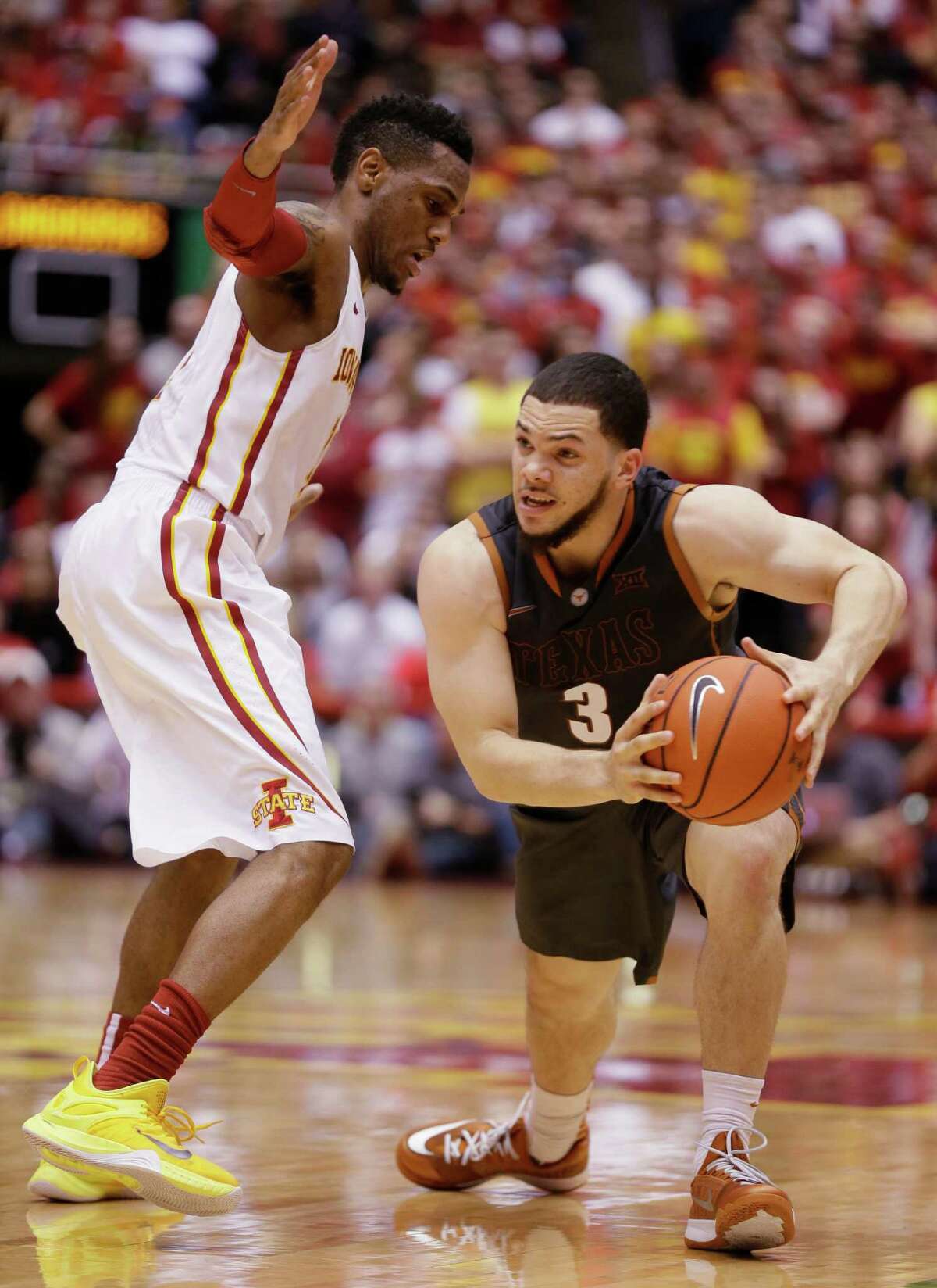 Texas guard Javan Felix looks to pass around Iowa State guard Monte Morris during the second half.