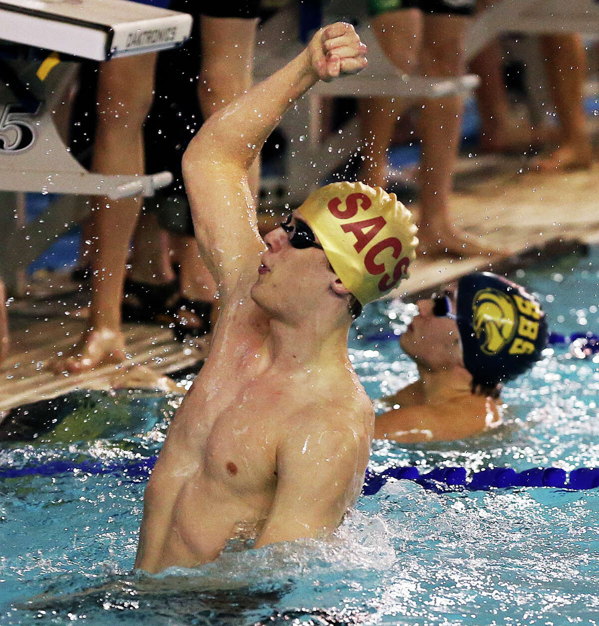 San Antonio Christian's John Johnson pumps his fist after coming from behind on the final leg of the 200 yard freestyle relay to win the gold in a close finish during the TAPPS Division II state championships at the Josh Davis Natatorium on February 13, 2015