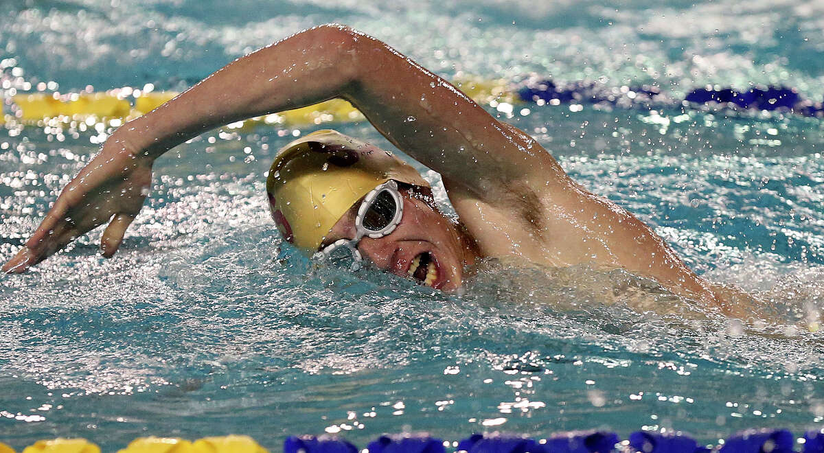 San Antonio Christian's Mason Riley races to a third place finish in the 200 yard freestyle during the TAPPS Division II state championships at the Josh Davis Natatorium on February 13, 2015