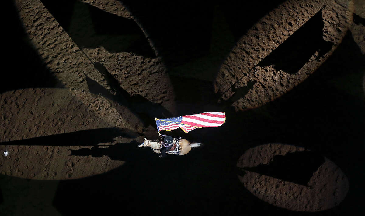 A member of the Jack Sellers Bexar County Palomino Patrol, Inc. presents the American flag during the grand entry of the 66th annual San Antonio Stock Show & Rodeo Friday Feb. 13, 2015. The rodeo, which was named 2014 Large Indoor Rodeo of the Year by the Professional Rodeo Cowboys?• Association (PRCA) for the last consecutive ten years, runs Feb. 12 - March 1.