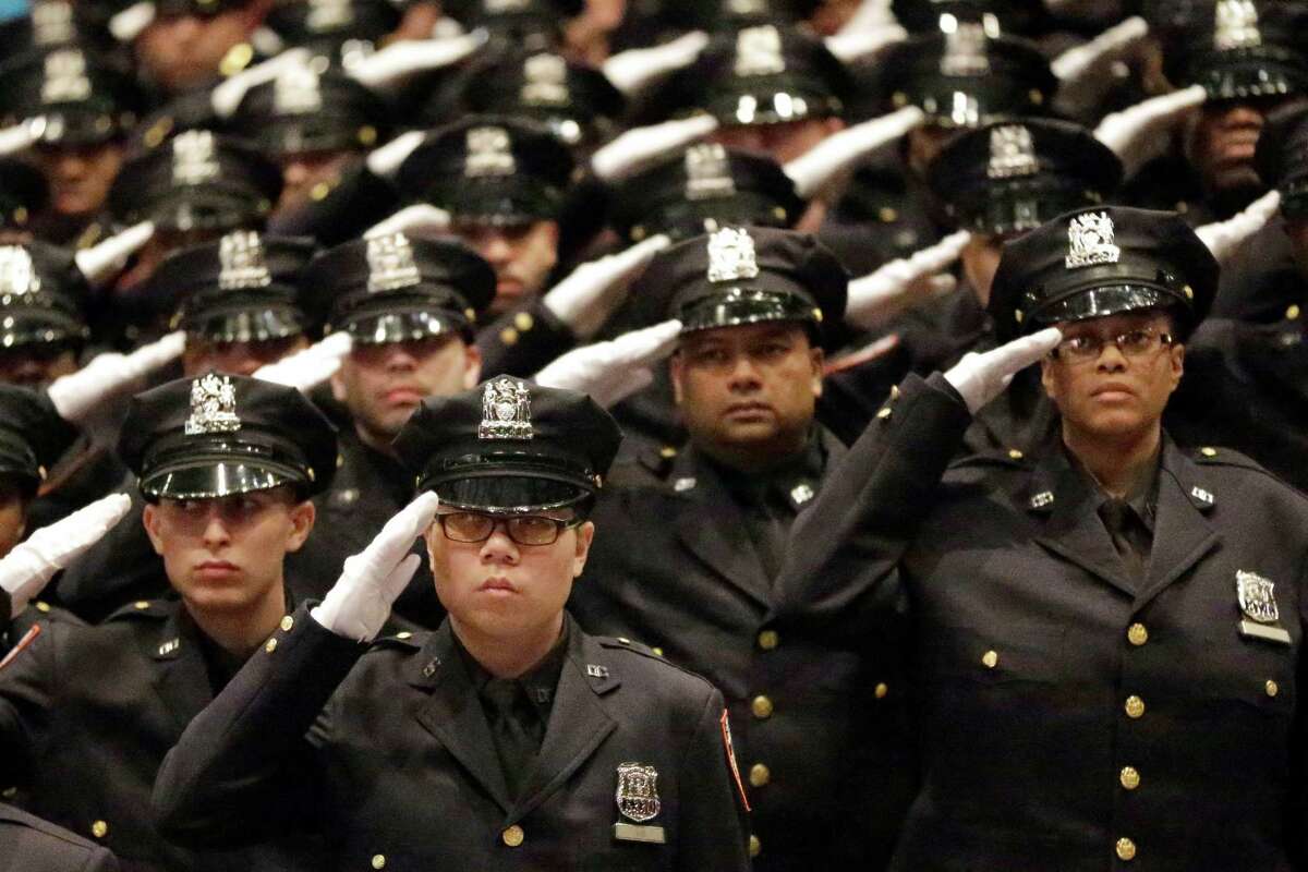 Department of Correction recruits salute the American flag during the pledge of allegiance during the DOC Promotion and Recruit Graduation Ceremony, Friday, Feb. 13, 2015, in the Bronx borough of New York. (AP Photo/Mary Altaffer) ORG XMIT: NYMA101