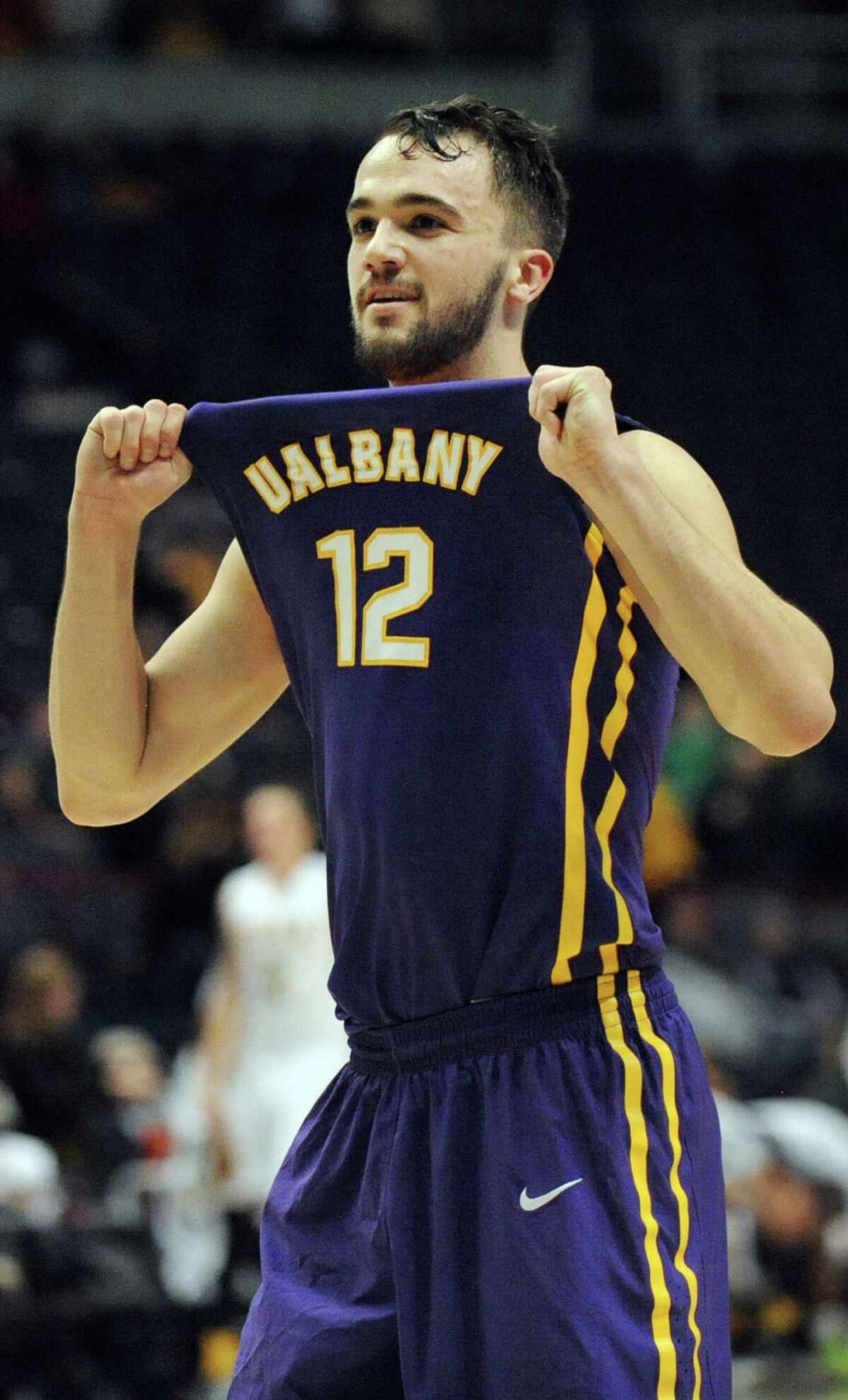 UAlbany's Peter Hooley shows his jersey to his fans when they win 77-68 over Siena during their basketball game on Saturday Dec. 13, 2014, at Times Union Center in Albany, N.Y. (Cindy Schultz / Times Union)