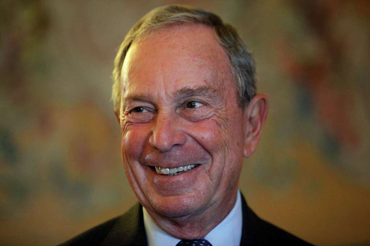 FILE - In this Sept. 16, 2014, file photo, former New York Mayor Michael Bloomberg smiles prior to be conferred with the Chevalier de la Legion d'Honneur by France's Foreign minister Laurent Fabius, at the Quai d'Orsay, in Paris. A Department of Investigation probe is finding that New York City?’s effort to modernize its 911 system is years behind schedule and $700 million over budget. The probe released Friday, Feb. 6, 2015, lays the blame at the feet of the former mayor's administration. (AP Photo/Thibault Camus, File) ORG XMIT: NY108