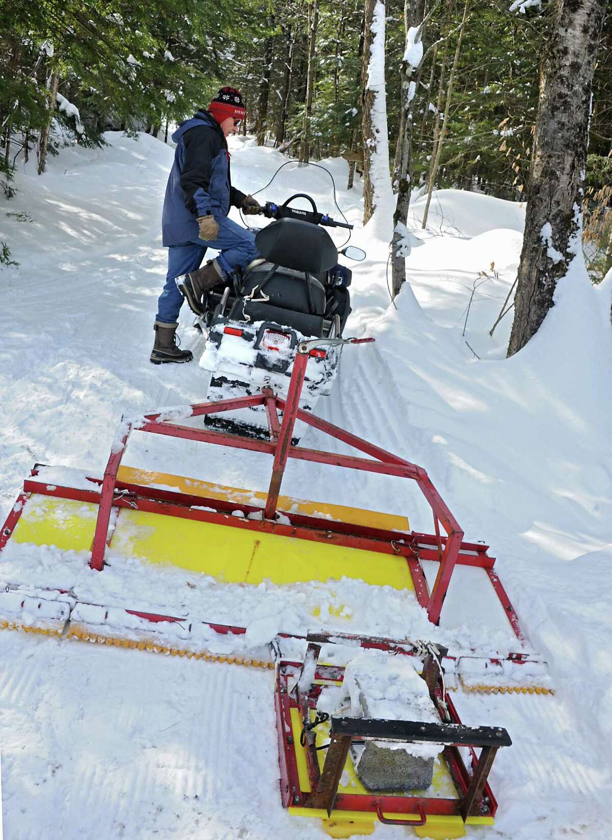 Pine Ridge Cross-Country Ski Area owner Walter Kersch climbs onto his snowmobile while grooming the ski trails on Wednesday, Feb. 11, 2015, at Pine Ridge Cross-Country Ski Area in Poestenkill, N.Y. (Lori Van Buren / Times Union)