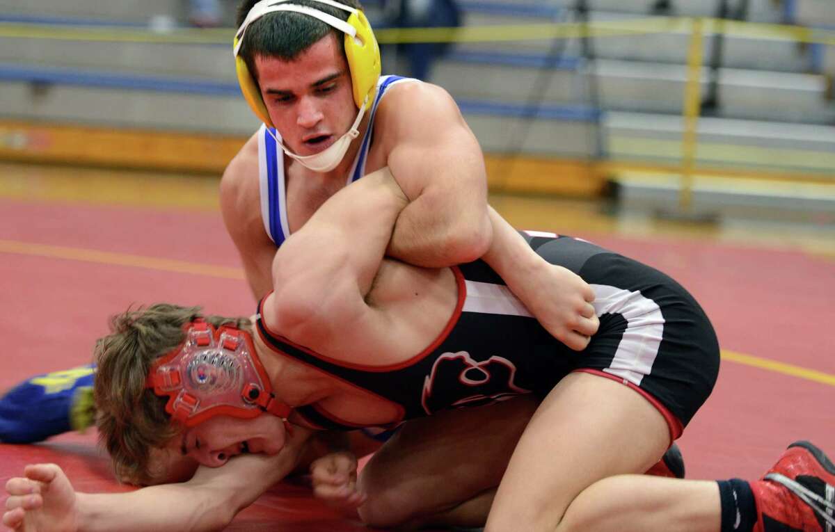 Newtown's Jame Leuci and Masuk's Dylan Palin compete in the 138 lb. weight class Saturday, Feb. 14, 2015, during the SWC wrestling championships at Bunnell High School in Stratford, Conn.