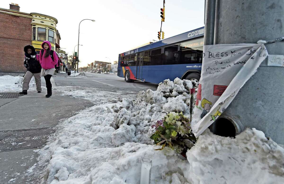 Children on their way to school look over at a memorial on the northwest corner of Quail Street at Central Avenue Friday morning, Feb. 13, 2015, where a four-year-old child was hit by a truck and killed Thursday in Albany. (Skip Dickstein/Times Union) ORG XMIT: MER2015021314470443