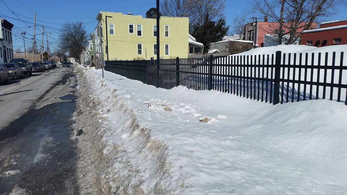 An unplowed sidewalk on Friday along an Albany Parking Authority lot at Sherman and Quail streets, a block from where Ashiqur Rahman was hit and killed on Thursday. (Chris Churchill/Times Union)