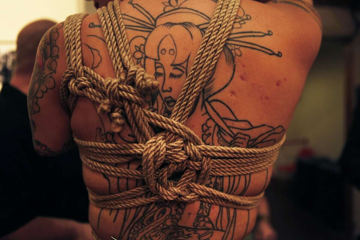 Tarah Una shows off Marshall Bradford's knot work during On the Edge 5: Erotic Art Exhibition at SOMArts in San Francisco, Calif. Friday, February 13, 2015.