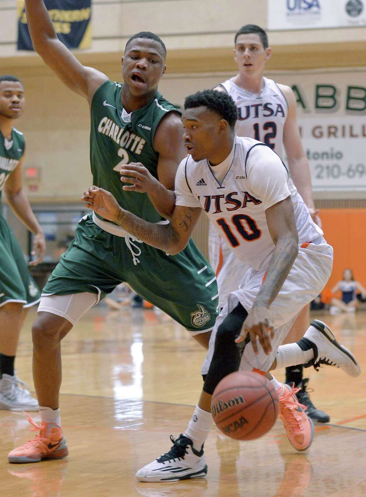 UTSA's Christian Wilson, right, drives around Charlotte's Torin Dorn during a college basketball game in 2015.