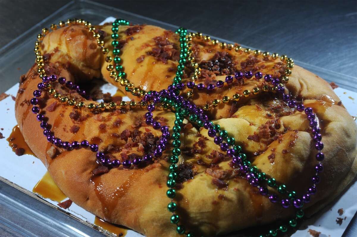 Topped with beads, bacon and two kinds of syrup, the boudin King Cake is a contemporary concoction of sweet and savory that Southeast Texans can use to celebrate Mardi Gras. Photo taken Wednesday, February 04, 2015 Guiseppe Barranco/The Enterprise