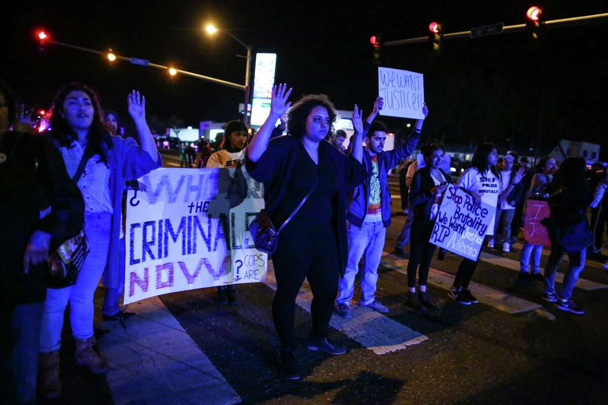 People gather in an intersection to stop traffic during a rally for Antonio Zambrano-Montes, Saturday, Feb. 14, 2015, in Pasco, Wash. Zambrano-Montes was shot and killed by Pasco police in Pasco on Tuesday. (AP Photo/seattlepi.com, Joshua Trujillo)