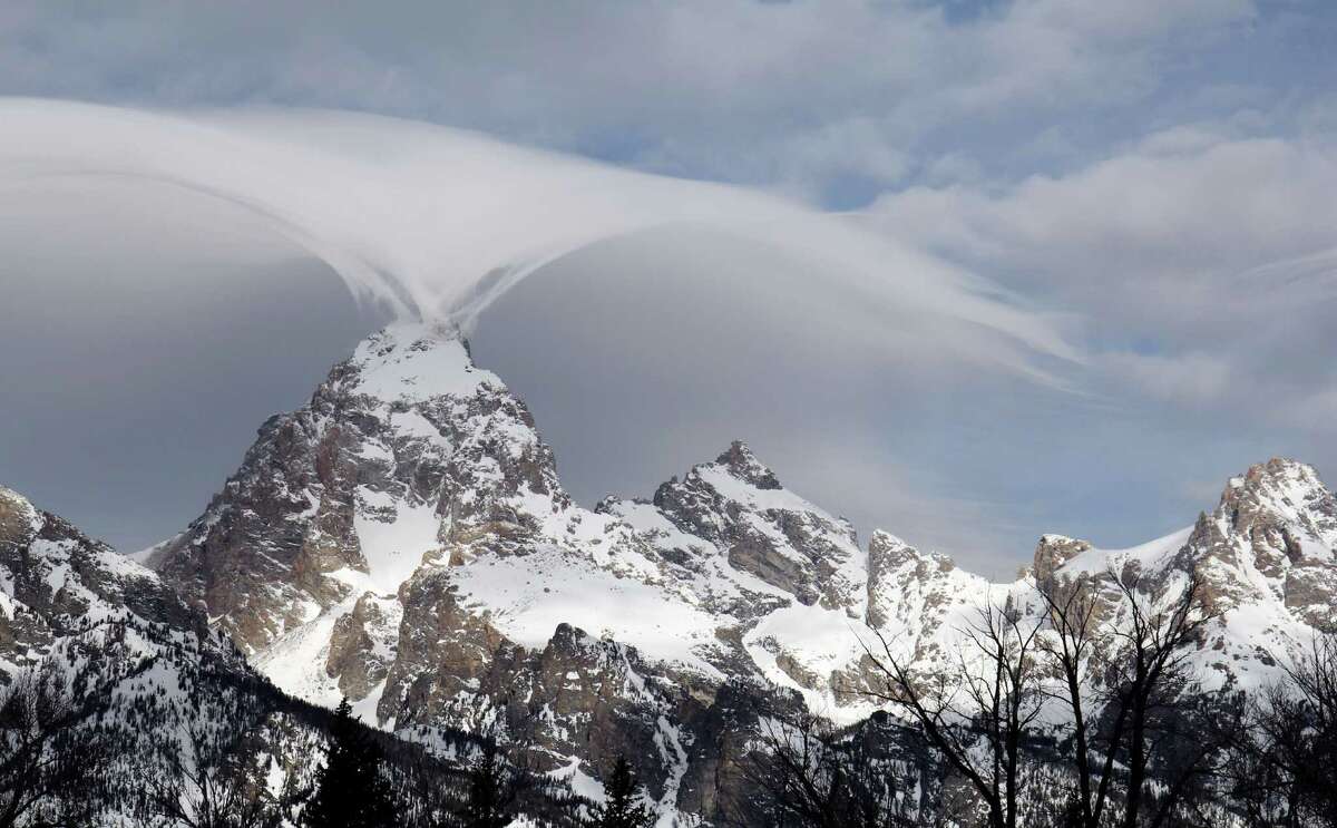 This photo taken Thursday, Feb. 12, 2015, and provided by the Grand Teton National Park shows, an unusual cloud formation across the summit of the Grand Teton in this view from the park's headquarters campus at Moose, Wyo.