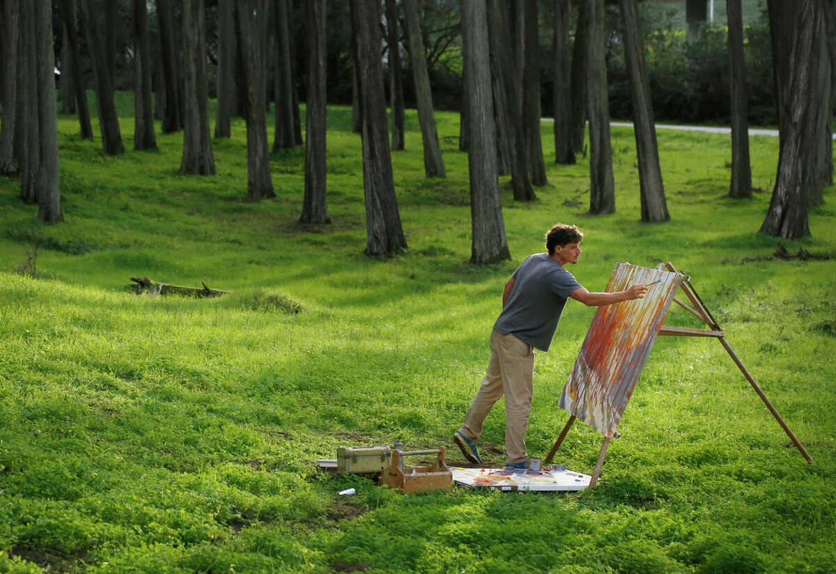 Nicholas Coley puts the finishing touches on a nearly complete painting in the Presidio in San Francisco, Calif.