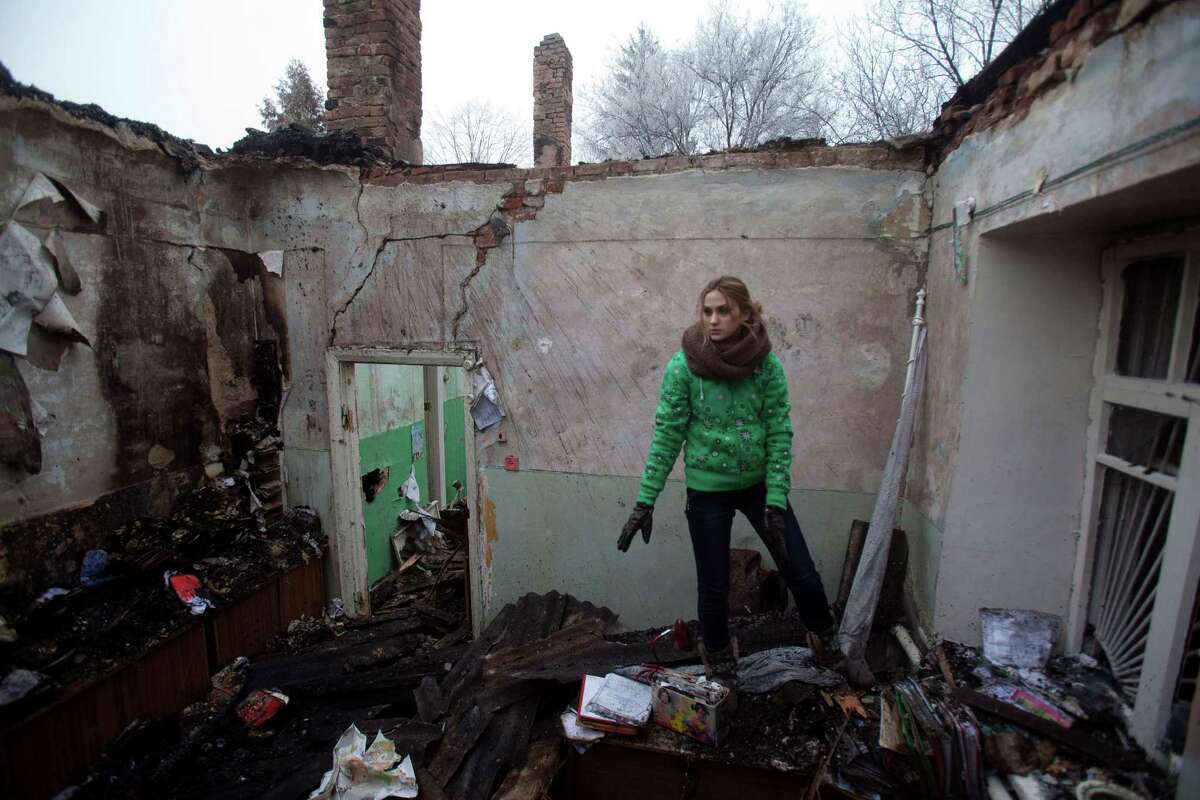 A member of the medical staff salvages items from the rubble of a destroyed clinic where she’d had worked in the eastern Ukraine village of Opytne.