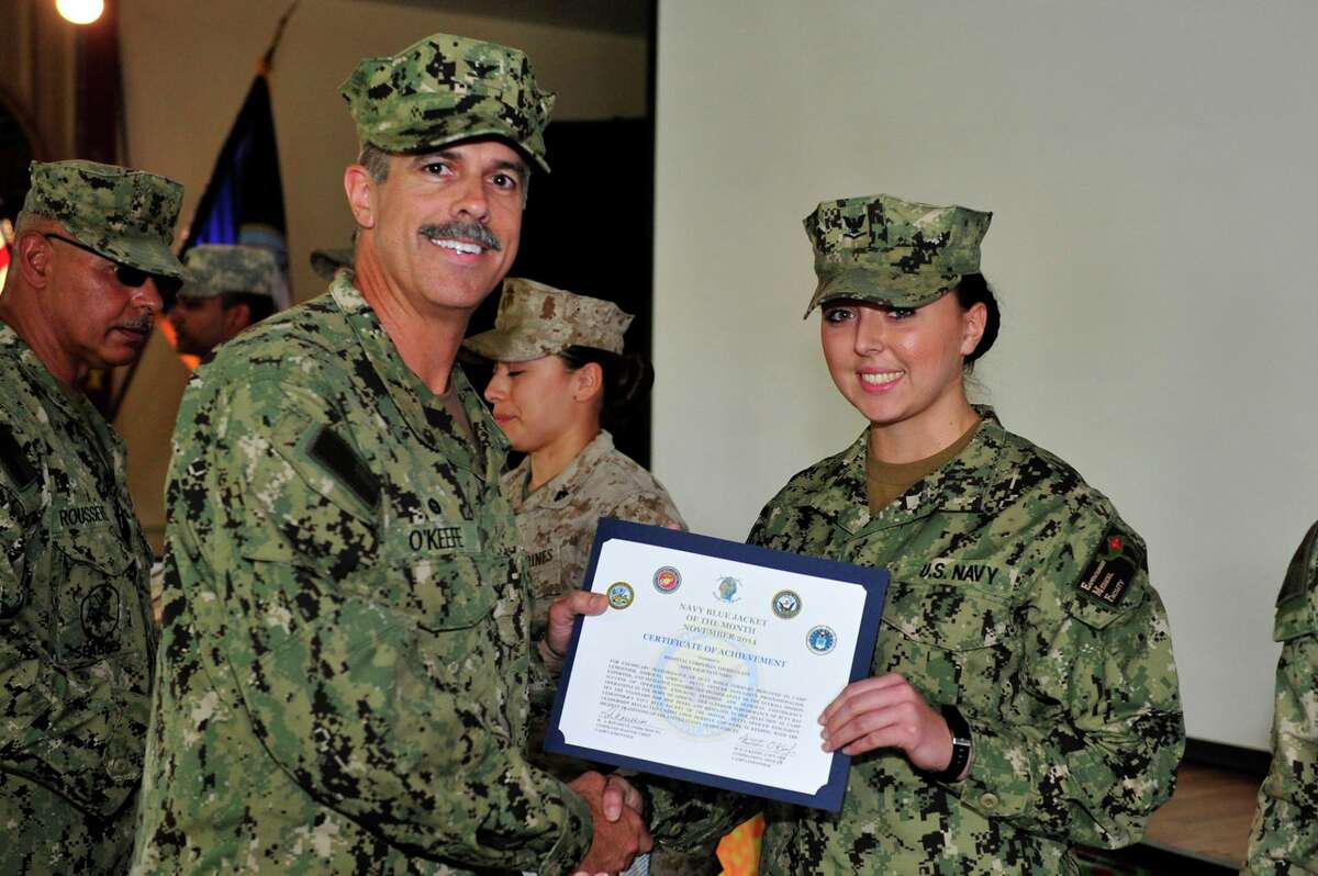 Navy Navy Captain Matt O?Keefe, commanding officer of Camp Lemonnier, Djibouti, present a Certificate of Achievement to Hospital Corpsman 2nd Class Ashleigh Panunzio of Clifton Park for her exemplary perforamnce at the base camp.