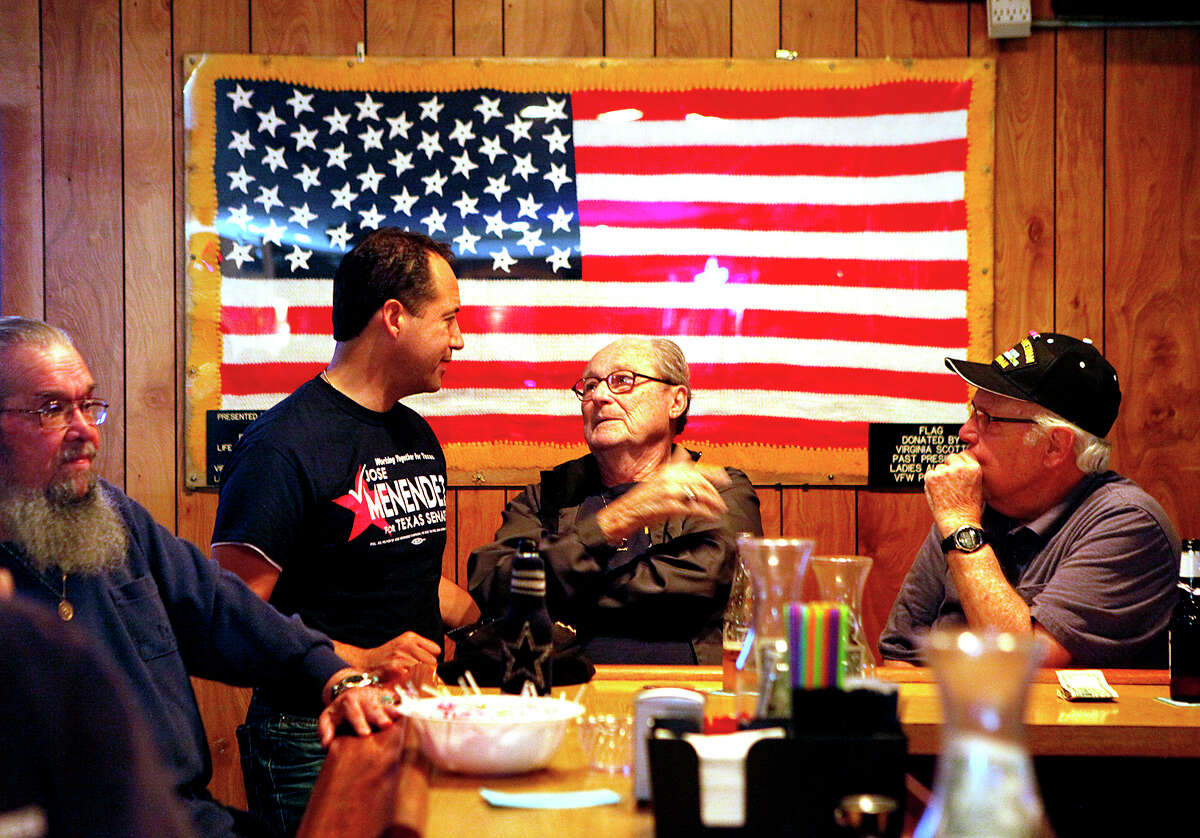 Sporting a campaign shirt, José Menéndez speaks with supporters Ernest Dalton (center) and Richard Huber at VFW Post 9174 on Pinn Road.