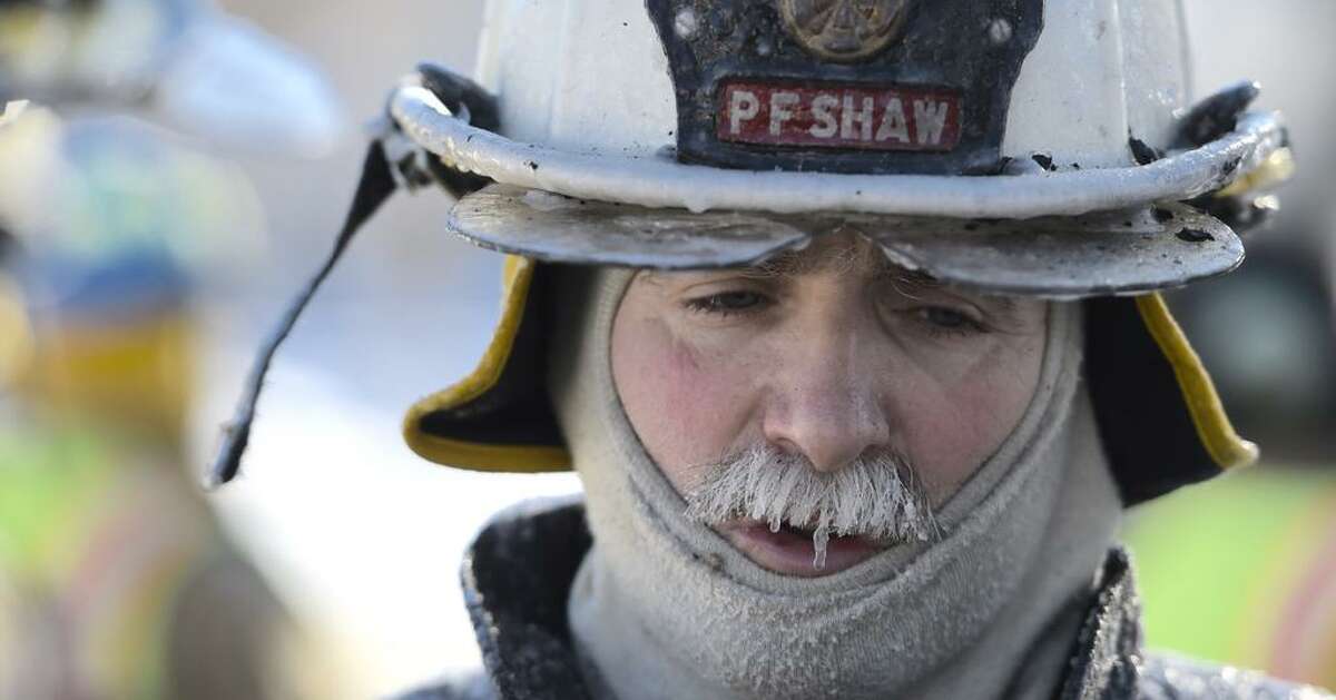 Malta Ridge Chief Pete Shaw had icicles hanging from his mustash due to the extreme cold at a house fire fire in Malta on Monday. (Skip Dickstein / Times Union)