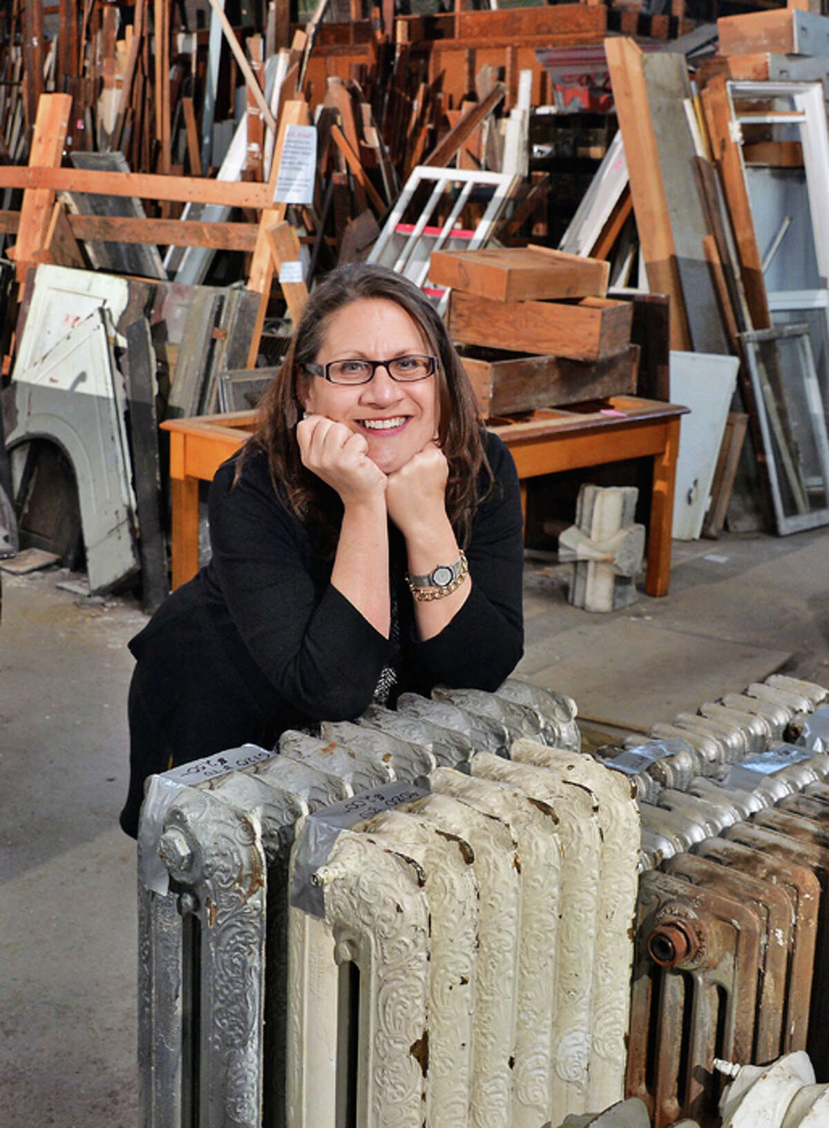 Executive director Susan Holland with cast iron steam and hot water radiators salvaged from the park South demolition now in Historic Albany Foundation's warehouse Tuesday Jan. 13, 2015, in Albany, NY.