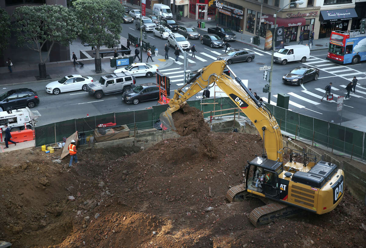 A construction crew moves dirt for a an office tower and Pine and Kearny streets in San Francisco, Calif. on Wednesday, Feb. 11, 2015. Construction continues to boom throughout the downtown area.