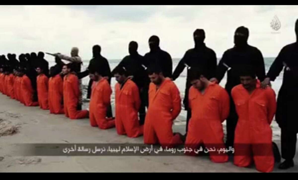 An image grab from a video posted Sunday on Youtube shows black-clad Islamic State militants in Libya with kidnapped Egyptian Coptic Christians on the Mediterranean coast of Libya. according to the video. The Egyptian Orthodox Church confirmed late on Sunday the killing of 21 Egyptian Coptic Christians kidnapped by Islamic State (IS) militant group in Libya, state-run MENA news agency reported. (Xinhua/Sipa USA/TNS)