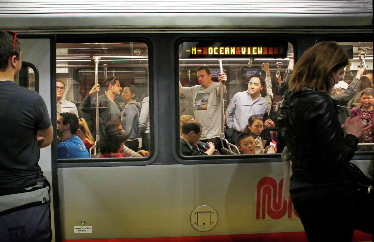 During the Friday evening commute, Muni riders pack an inbound M-line light rail train in San Francisco.