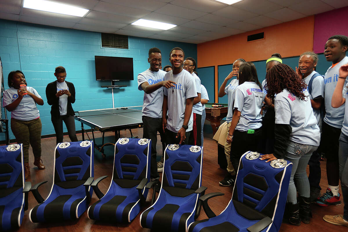 Brandon Miller, 18, center left, and Ashanti Richardson, 17, get a first look at the renovated teen center at the Boys and Girls Club of San Antonio Eastside Branch, Monday, February 16, 2015. The room features three areas for playing, studying and socializing. It was funded by Aaron's.