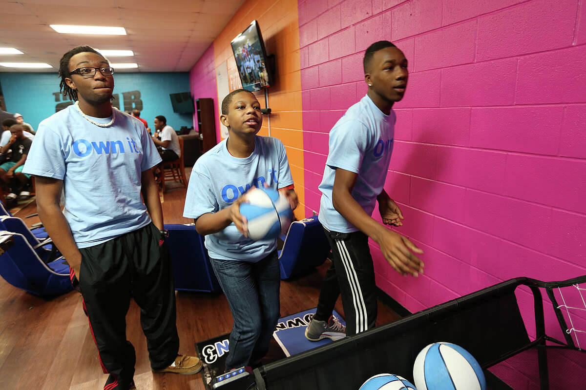 From left, London Watkins, 17, Jalin King, 14 and Trevon Savage, 17, play in the renovated teen center at the Boys and Girls Club of San Antonio Eastside Branch, Monday, February 16, 2015. The room features three areas for playing, studying and socializing. It was funded by Aaron's.