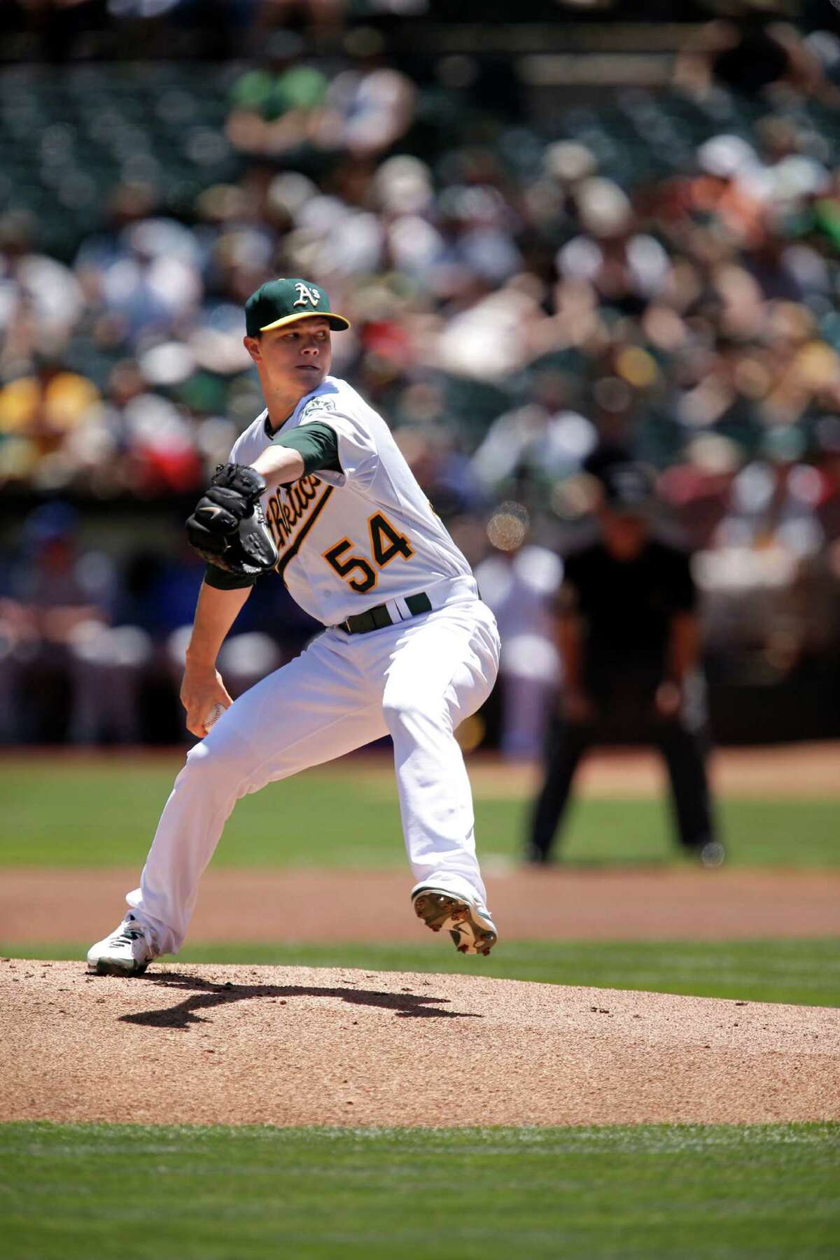 Oakland starting pitcher Sonny Gray, (54) throws in the 1st inning, as the Athletics went on to beat the Texas Rangers 4-2 at O. co Coliseum in Oakland, Calif. , on Wednesday June 18, 2014.