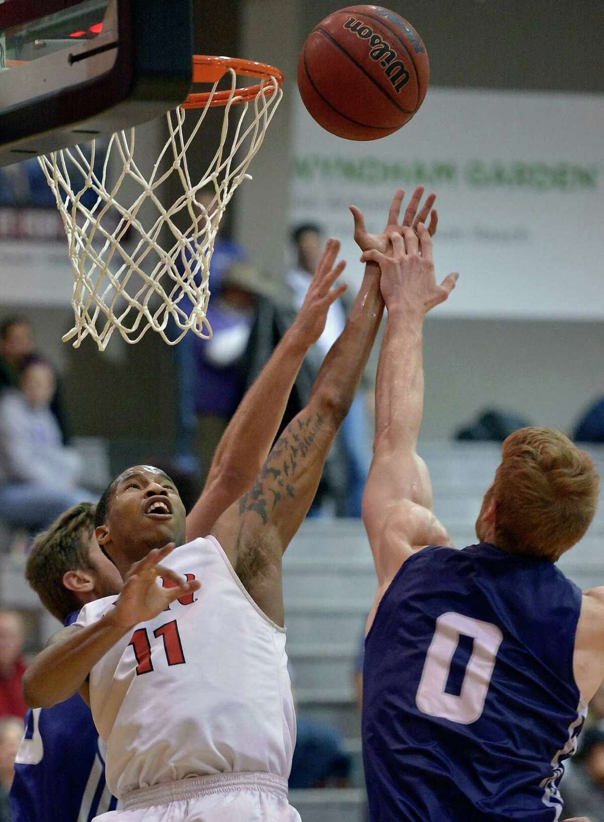 Incarnate Word's Denzel Livingston, left, shoots against Stephen F. Austin's Thomas Walkup during a college basketball game, Monday, Feb. 16, 2015, at the University of the Incarnate Word in San Antonio. Stephen F. Austin won 90-76. (Darren Abate/For the Express-News)
