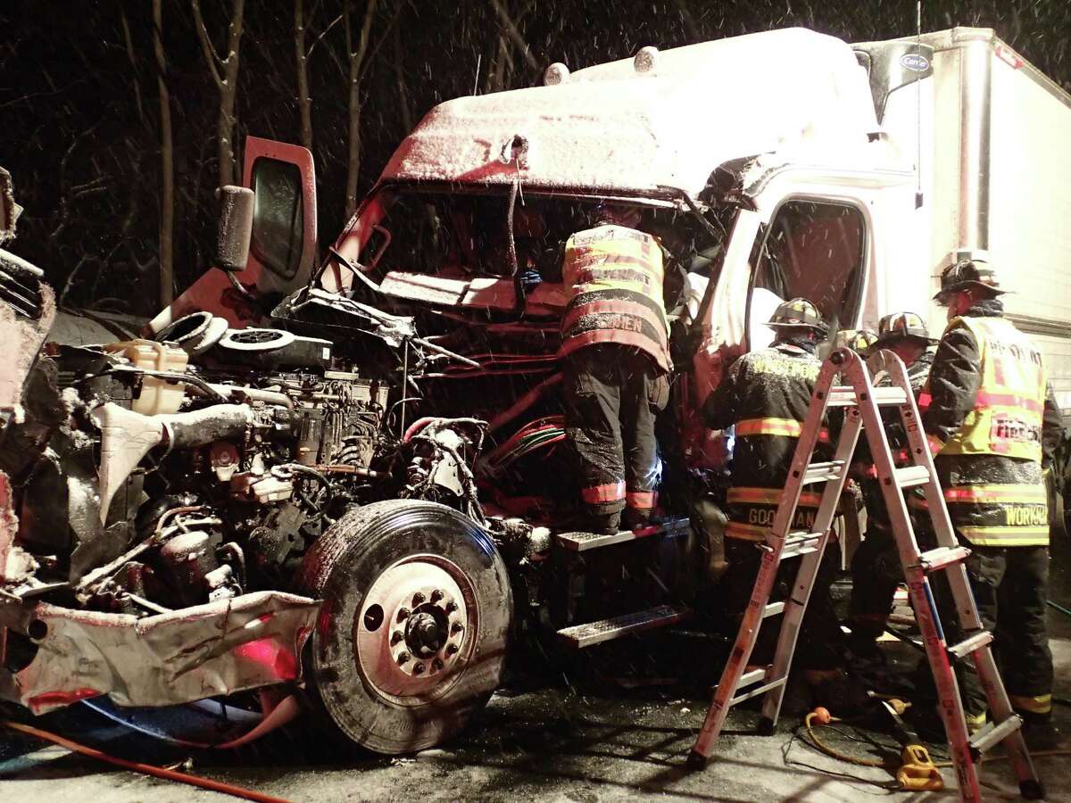 Firefighters work to extricate the driver of a tractor-trailer truck that crashed early Tuesday on Interstate 95 between northbound Exist 18 and 19.
