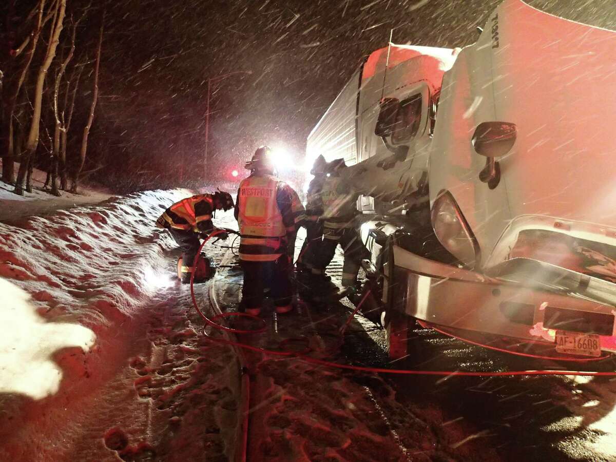 Firefighters work to extricate the driver of a tractor-trailer truck that crashed early Tuesday on Interstate 95 between northbound Exist 18 and 19.