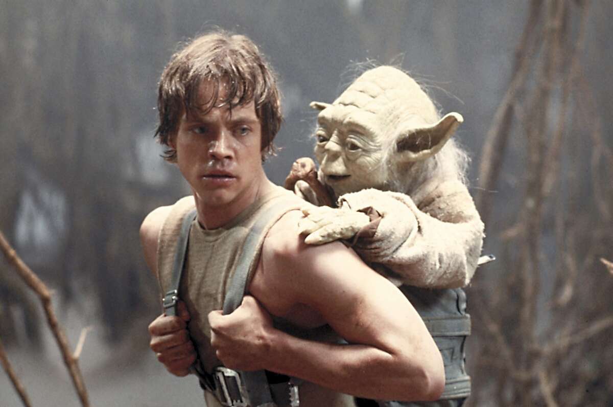 This image provided by Lucasfilm Ltd. shows Mark Hamill as Luke Skywalker and Yoda in a scene from the 1980 movie "Star Wars Episode V: The Empire Strikes Back." 