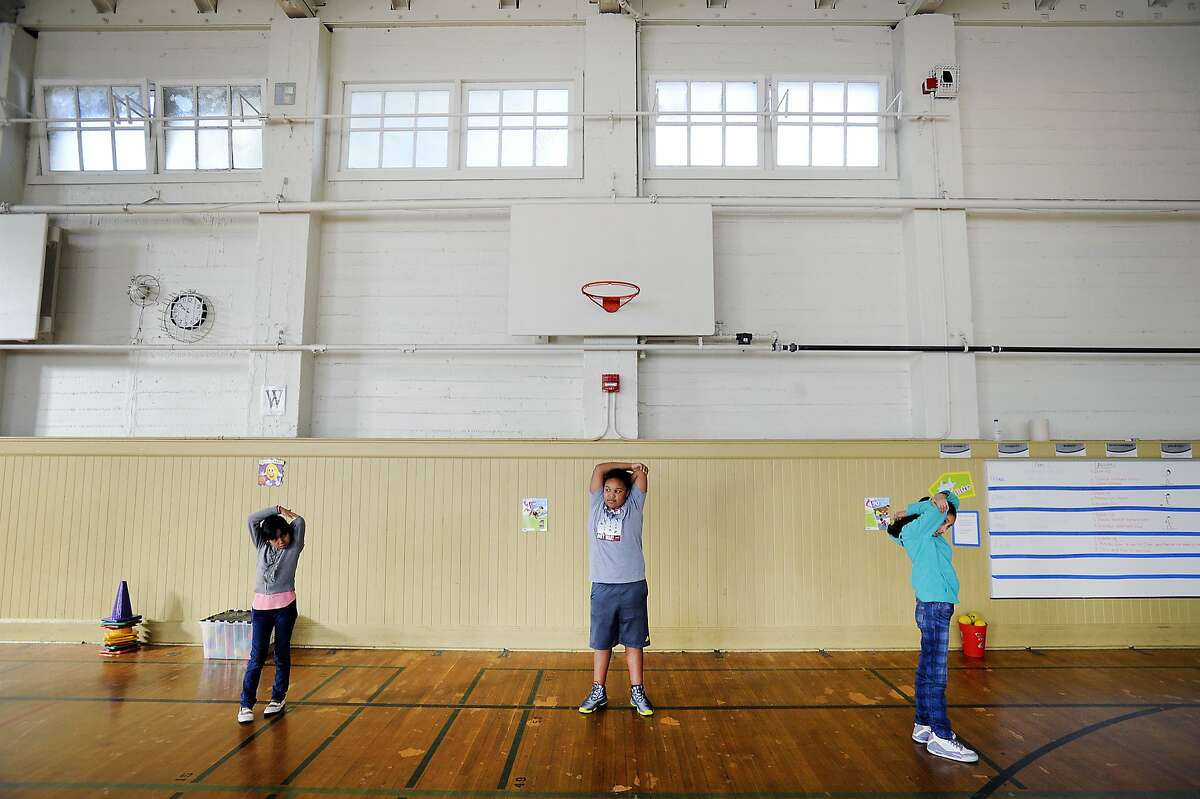 Students of Frank Lara's 4th grade class stretch during physical education held in the gymnasium at Buena Vista Horace Mann school in San Francisco, CA, on Thursday, February 12, 2015.