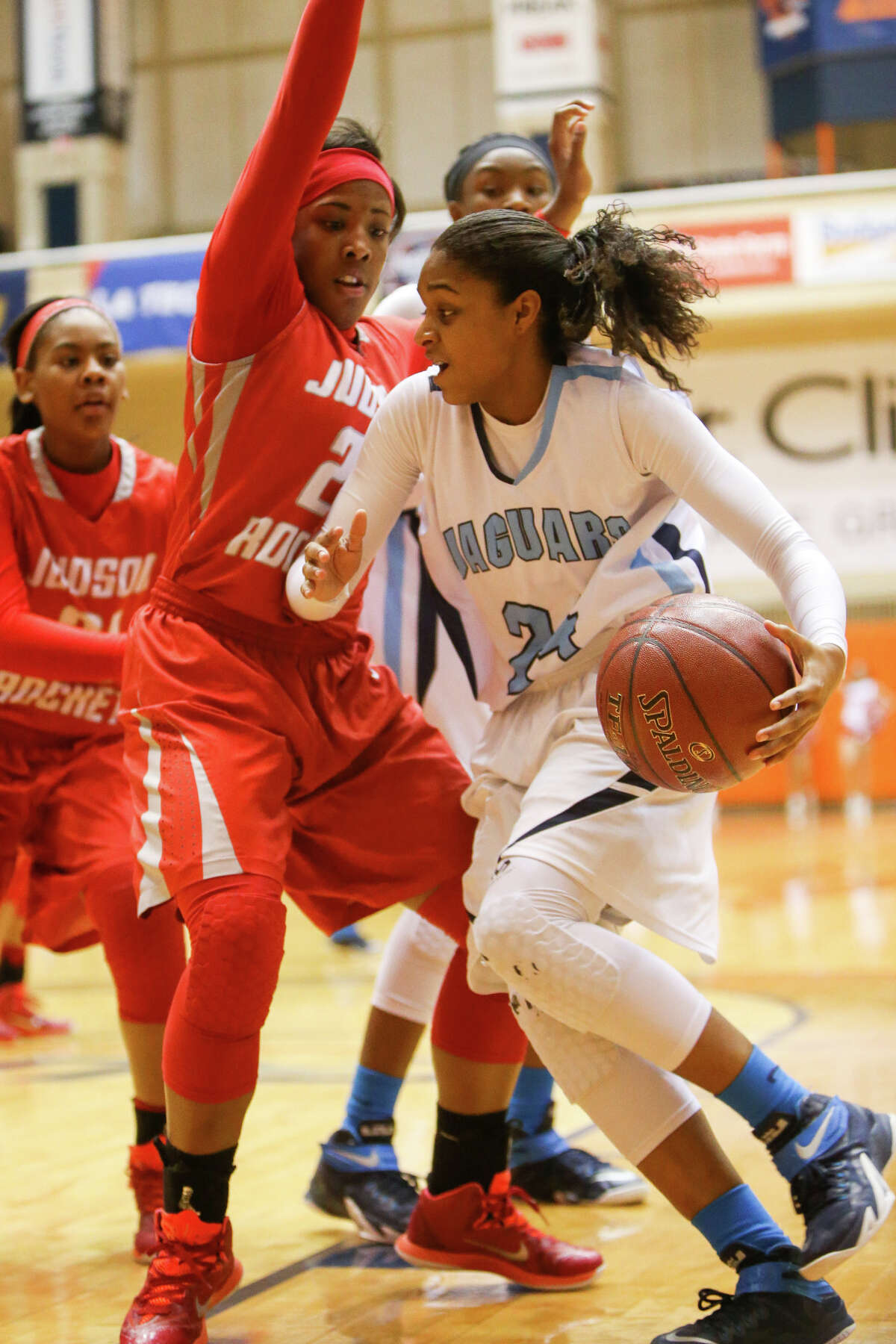 Johnson’s Desiree Caldwell (right) tries to drive past Judson’s Angel Charles during the first half of their 6A first round basketball game at the UTSA Convocation Center on Feb. 16, 2015.