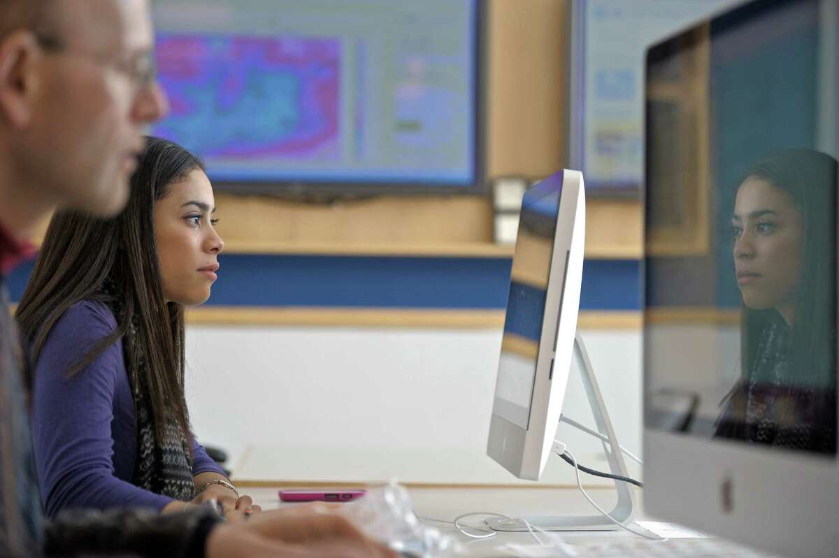 Ana Cabrera, a second semester freshman in the Meteoroligical Studies program at Western Connecticut State University creates weather maps for newspapers in the WCSU Weather Center, on Wednesday, February 18, 2015, in Danbury, Conn. Gary Lessor, Assistant Director of the Weather Center works next to her.