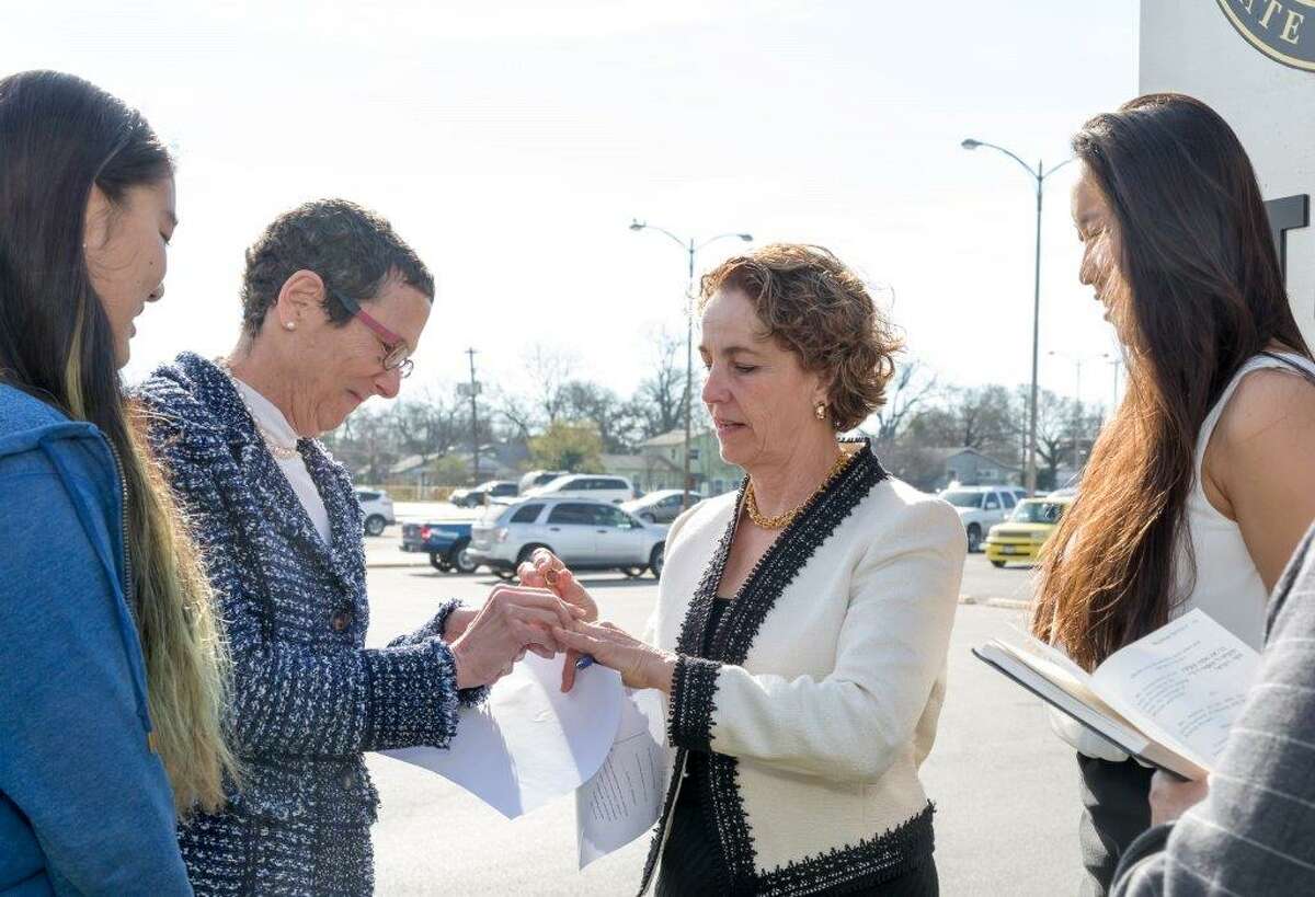 Sarah Goodfriend (second from left) marries Suzanne Bryant outside of the Travis County Clerk's Office in Austin on Thursday, January 19, 2015. They are flanked by their daughters Ting, 13, and Dawn, 18.