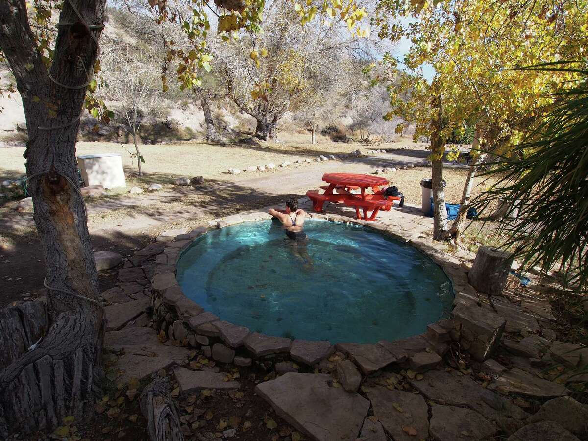 A round outdoor hot tub is among the soaking spots at the quiet﻿ and remote Chinati Hot Springs resort in West Texas.
