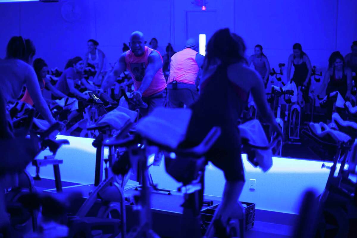 Will Longoria, an instructor at RIDE, leads a Rihanna and Justin Timberlake themed indoor cycling excercise class in the Heights.