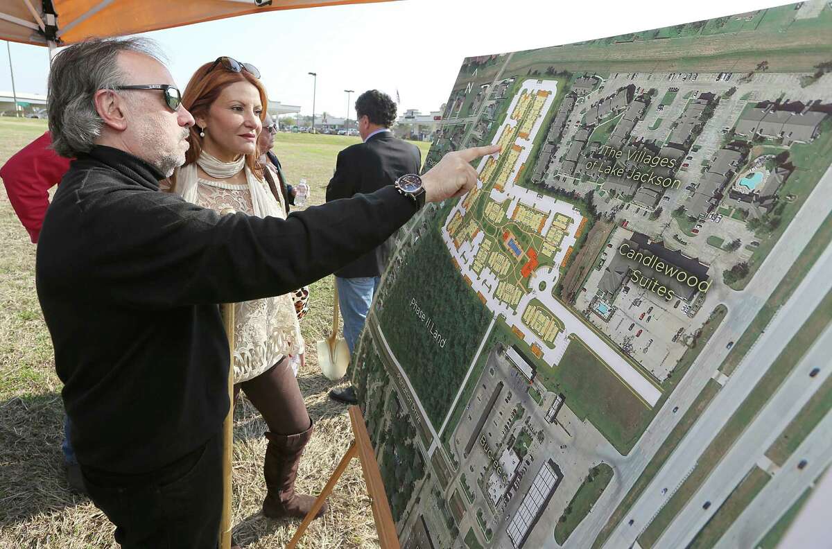 From left to right, Ralph and Mimi Howard look over the plans for a new apartment complex during a ground breaking on Thursday, February 12, 2015. Lake Jackson, the town of 26,000 an hour south of Houston, may be poised for a rebirth, spurred by billions in industrial construction by petrochemical industry in the Brazosport area.(Photo: Thomas B. Shea/For the Chronicle)