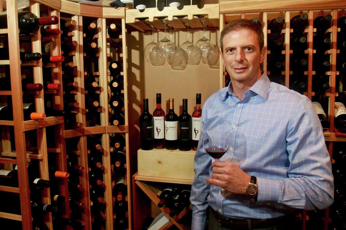 Sergio Weitzman of SERCA Wines enjoys a glass of his 2012 Malbec Gran Reserva in his private wine cellar in Houston. ﻿