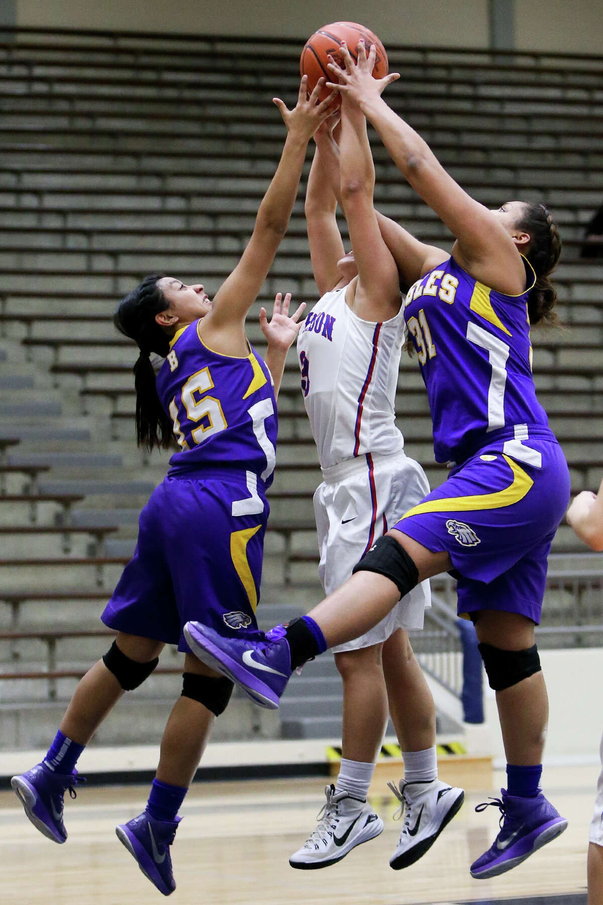 Brackenridge's Clarissa Rodriguez (left) and Skyler Reyna battle for a rebound with Jefferson's Angela Hardcastle (center) during the first half of their game at the Alamo Convocation Center on Tuesday, Feb. 10, 2015. Brackenridge beat Jefferson 66-38. MARVIN PFEIFFER/ mpfeiffer@express-news.net