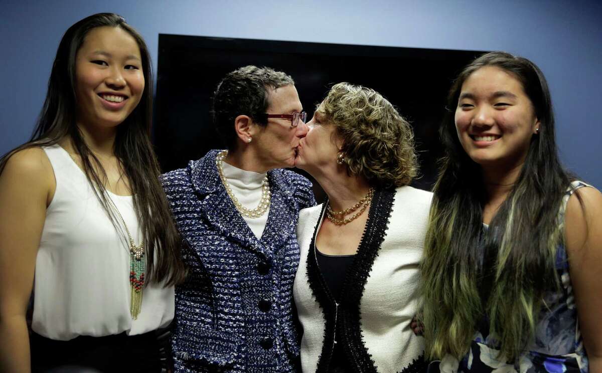 Sarah Goodfriend, left center, and Suzanne Bryant, with their daughters, Dawn, left, and Ting in Austin. A one-time court order issued for medical reasons allowed their nuptials.