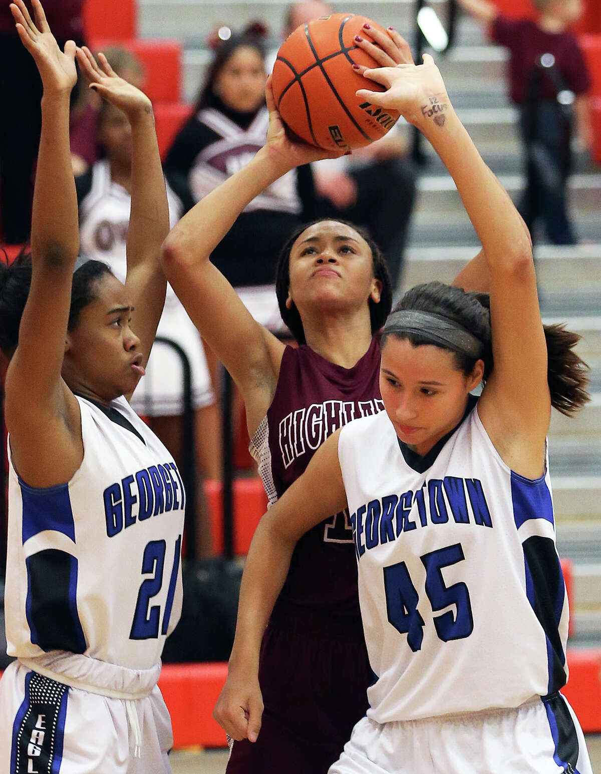 Owls forward Jazmine Jackson takes a shot over two George- town players in a 5A second- round playoff game Feb. 19.