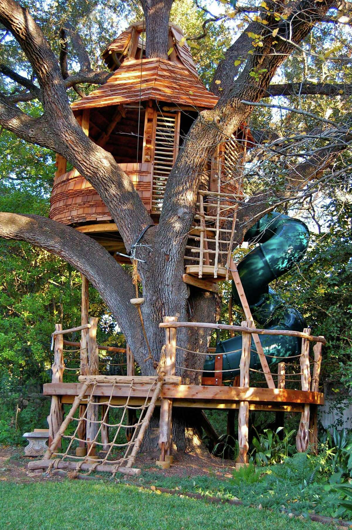 A treehouse with climbing wall, spiral slide and swings wraps around a large live oak in a San Antonio backyard. It is one of two works by Attie Jonker of Azzanarts that will be featured on “Treehouse Masters” on Feb. 27.
