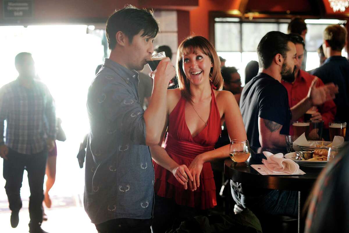 Alex Wu and Molly Shelestak chat over drinks during a Valentine’s Day singles event celebrating the launch of the new dating app the Catch at Mayes Oyster House in San Francisco.